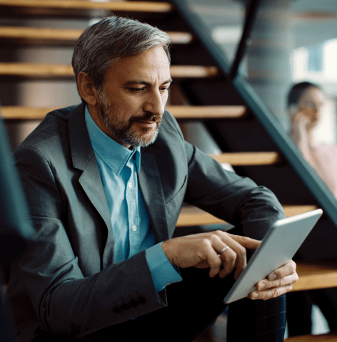 Person in business outfit using a tablet